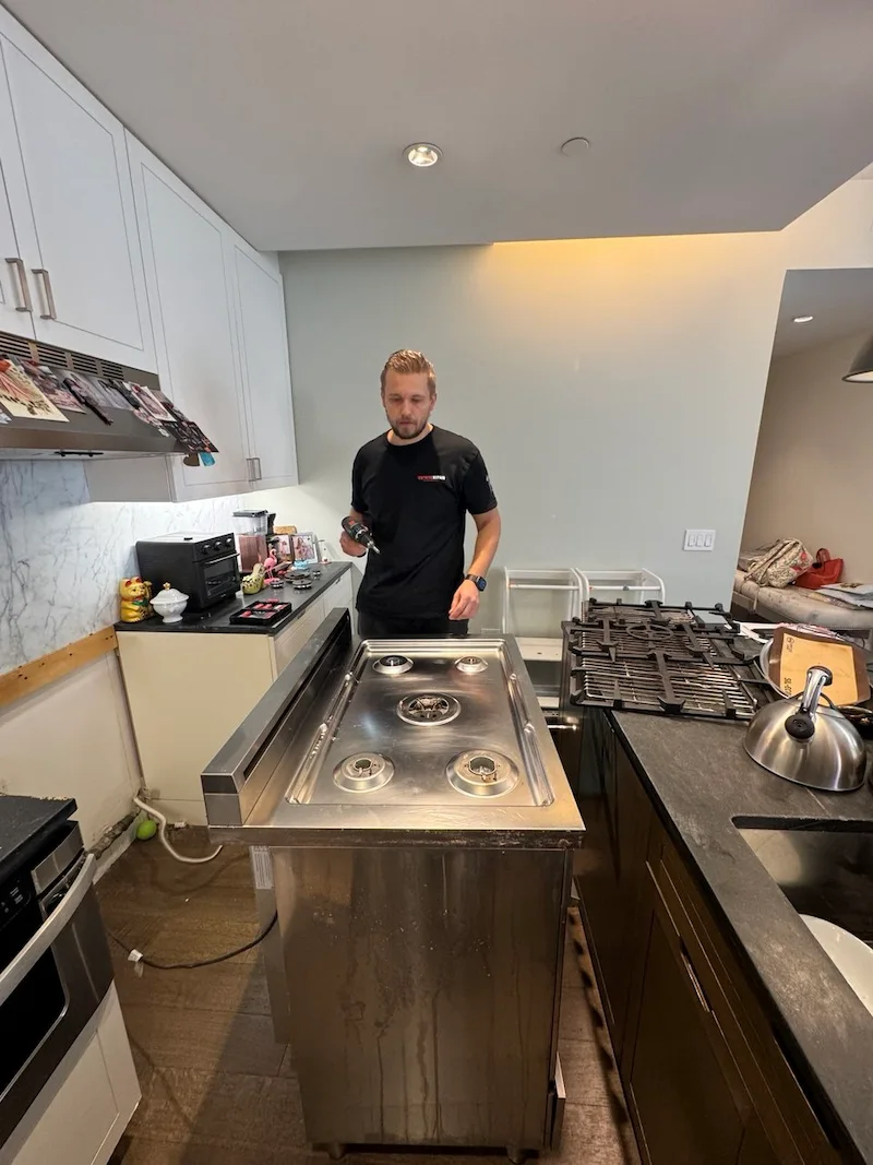 Elevate Repair technician servicing an appliance in a Denver home