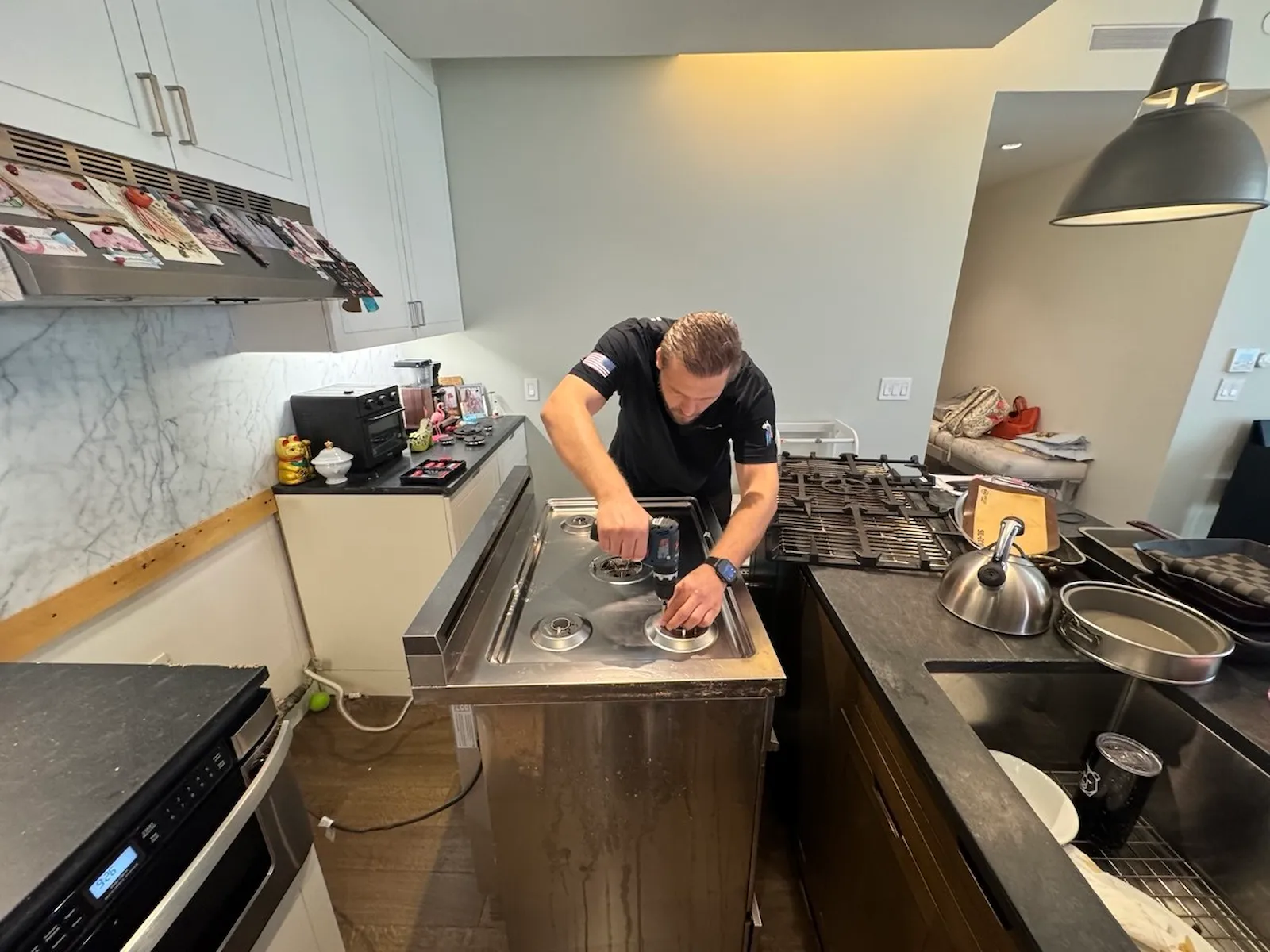 Elevate Repair technician repairing a cooktop in a Denver home